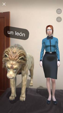A screenshot of the Mondly AR app that shows a woman and a lion standing on my bed.