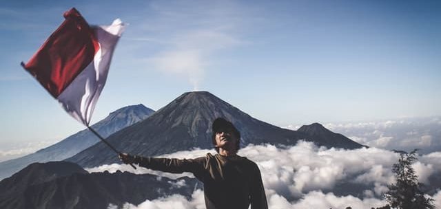 man waving indonesian flag