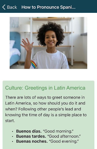 Screenshot from the Rocket Spanish app. It shows a child waving and below is a written description of how to greet someone in Latin America