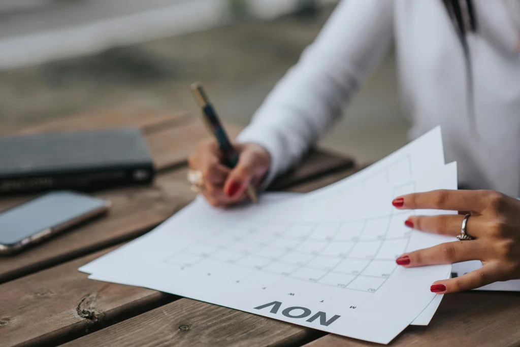 Woman writing on a calendar